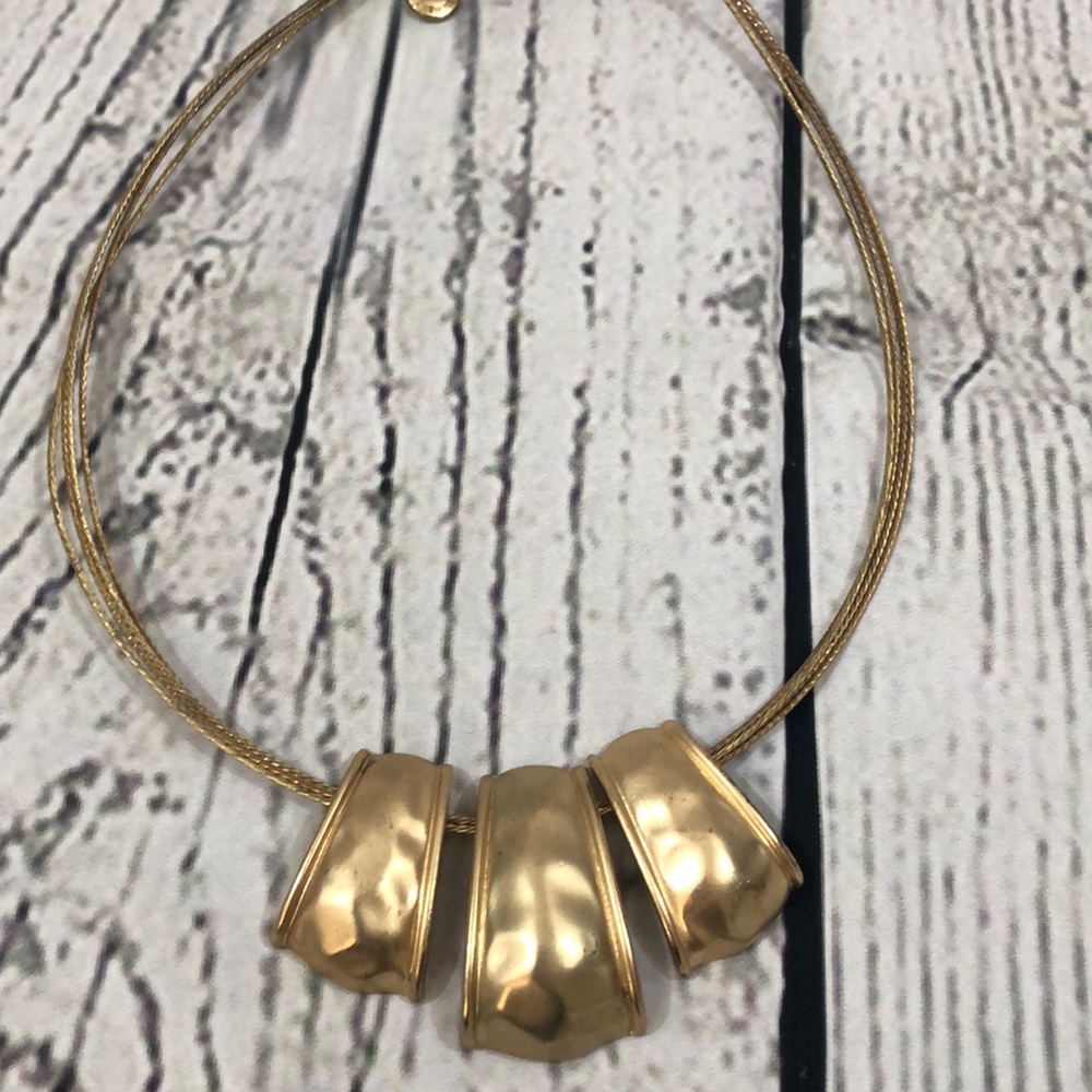 Gold metal scoop necklace